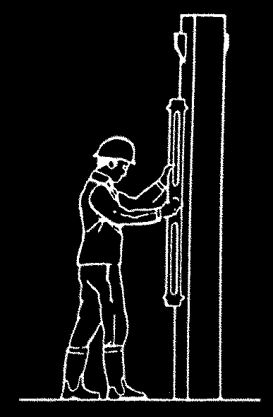 A construction worker using a spirit level to check the vertical align