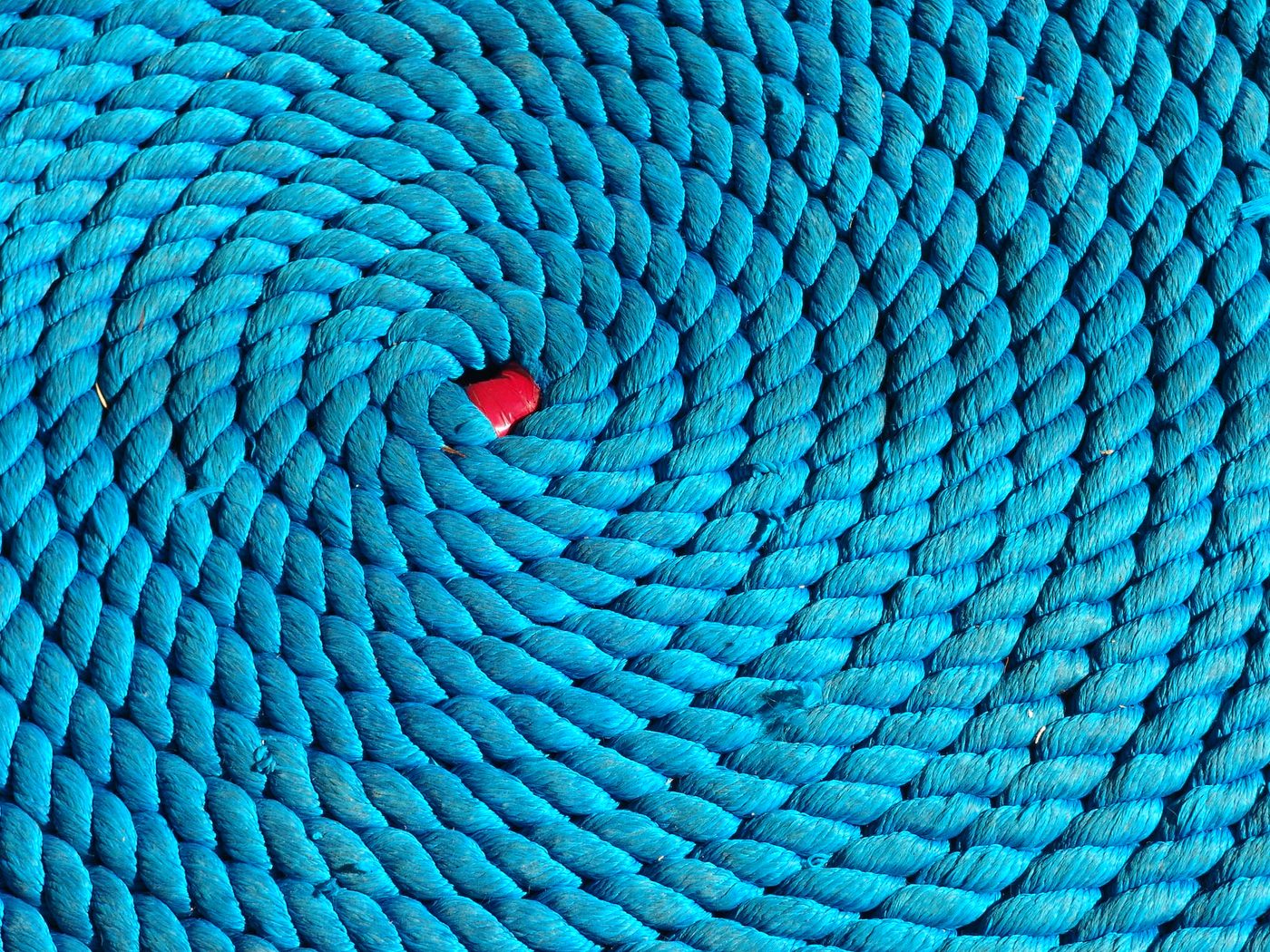 Coiled blue braided rope with red core