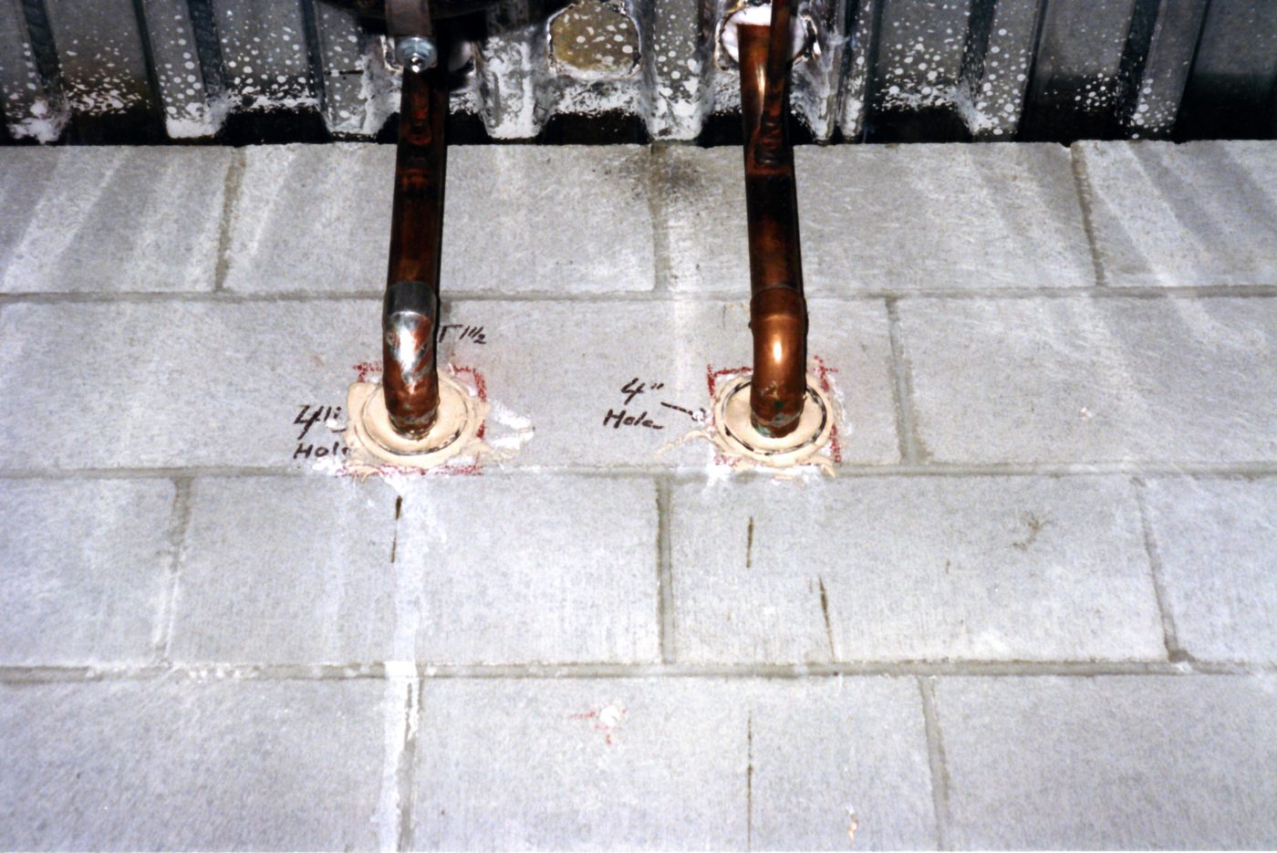 Copper pipes installed through wall holes