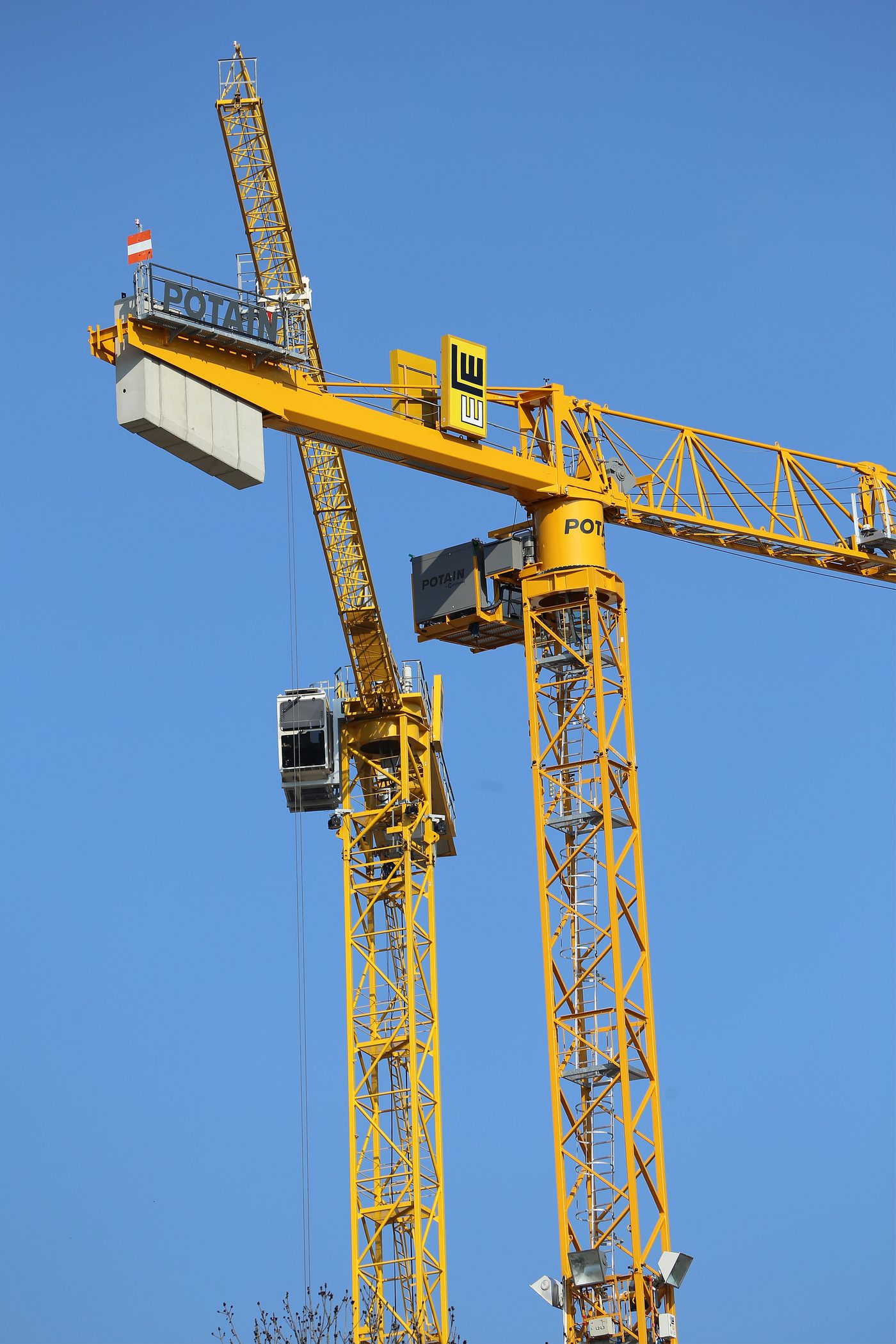 Yellow tower cranes at construction site
