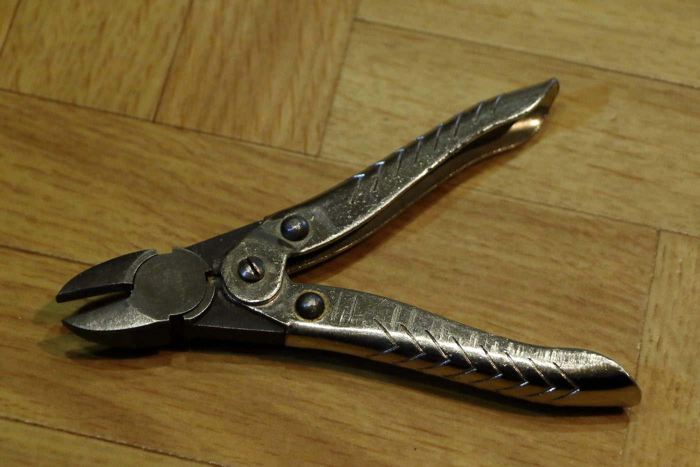 Metal cutting plier on wooden surface