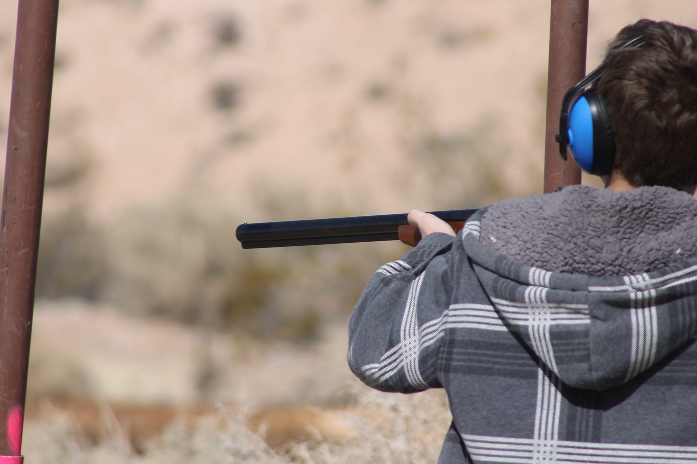Person wearing blue ear protection earmuffs
