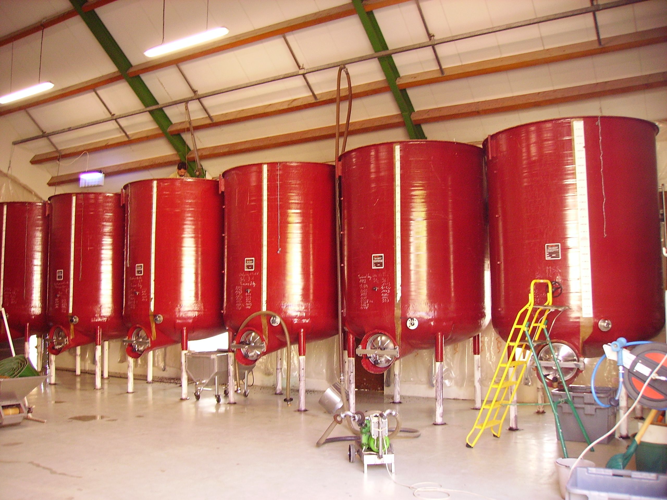 Red fiberglass tanks in an industrial setting