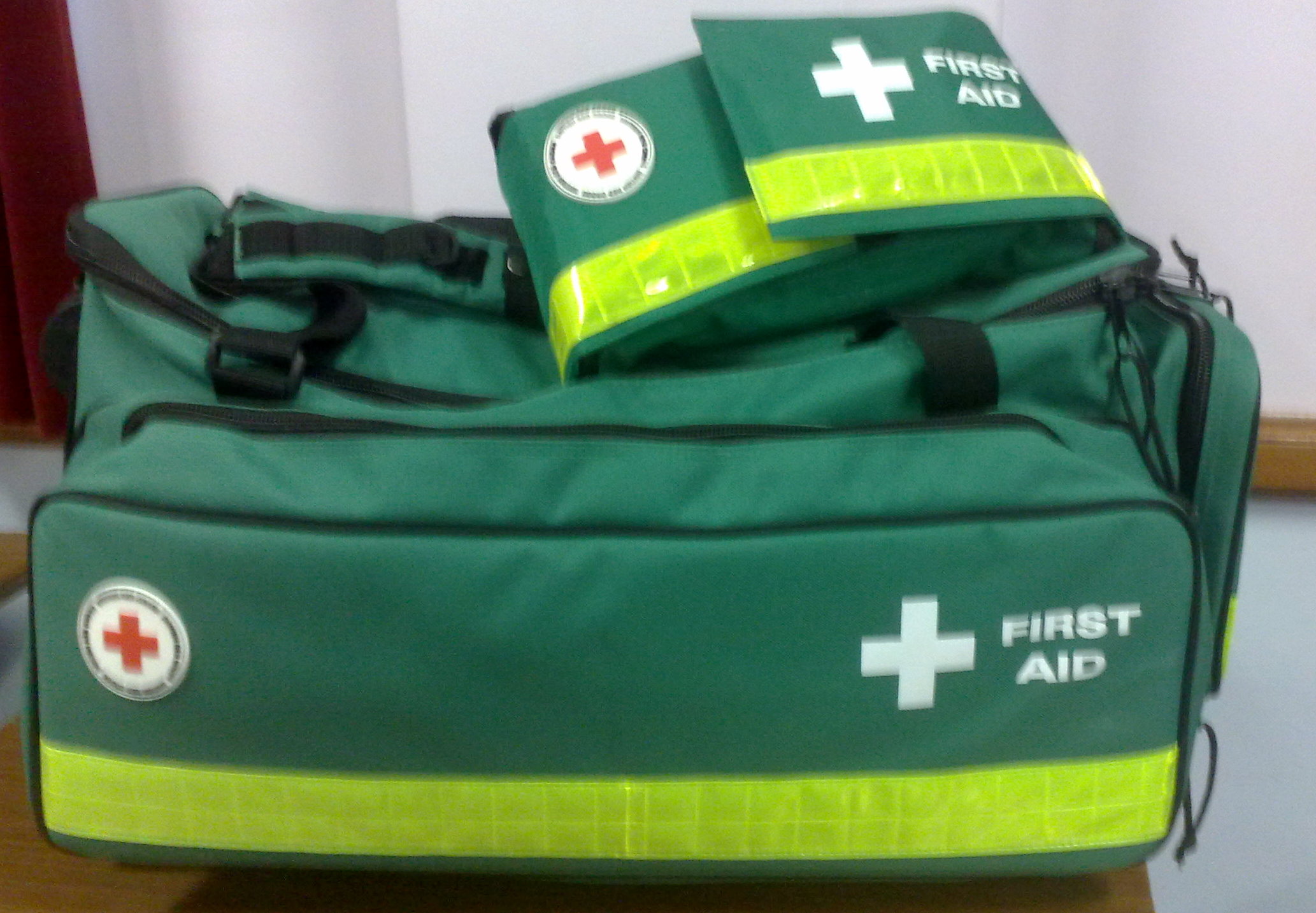 Green first aid kits with cross symbols