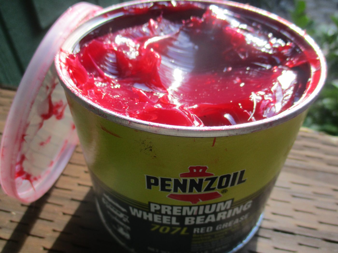 Open can of red wheel bearing grease