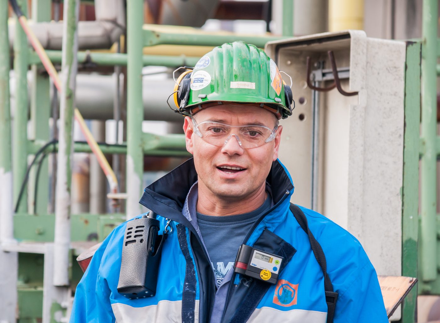 Green hard hat worn by worker