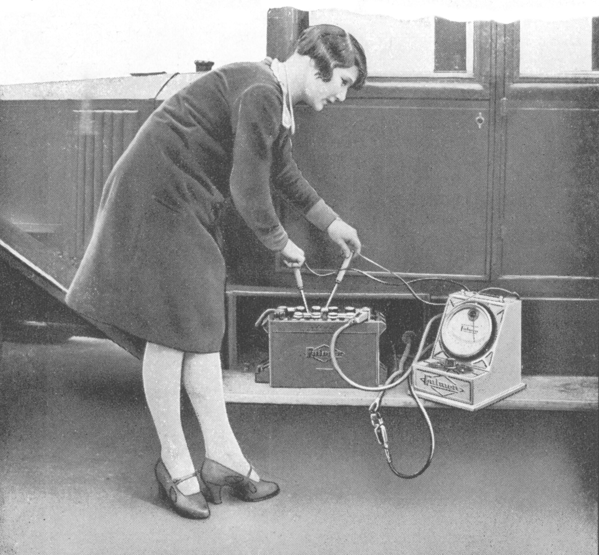 Woman testing a lead-acid cell battery