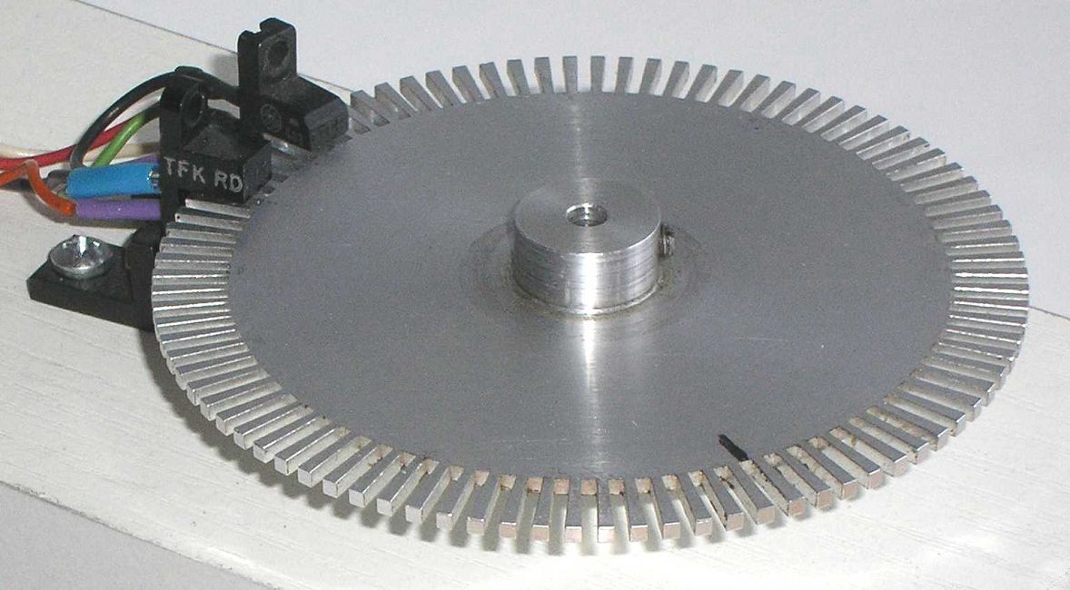 Optical encoder with slotted disk and sensor