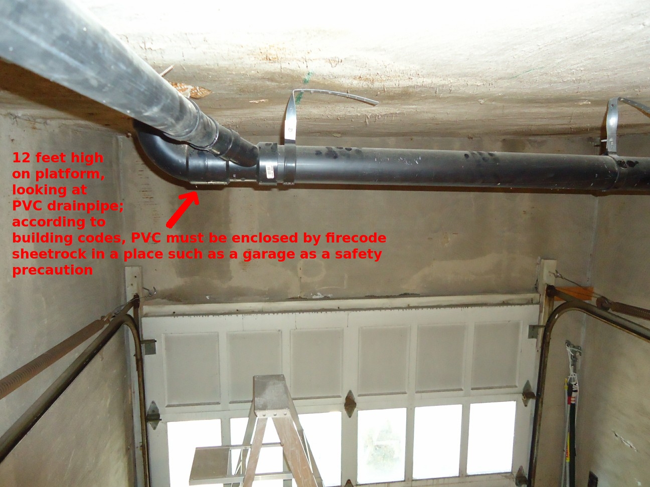 PVC drainpipe installed in a garage ceiling