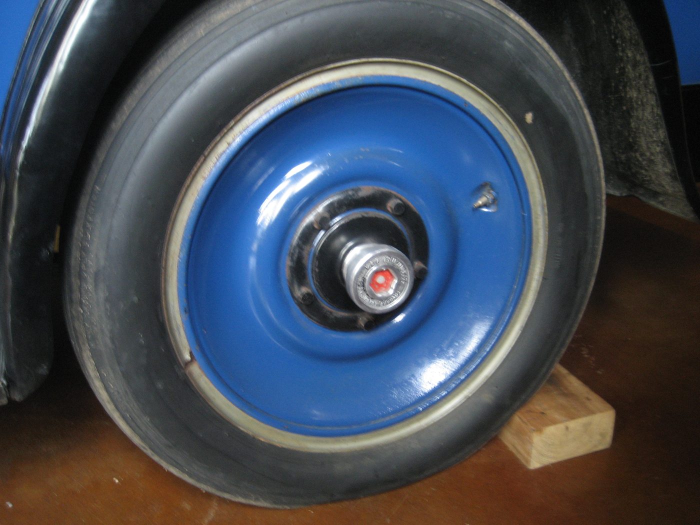 Blue pressed steel wheel on vehicle
