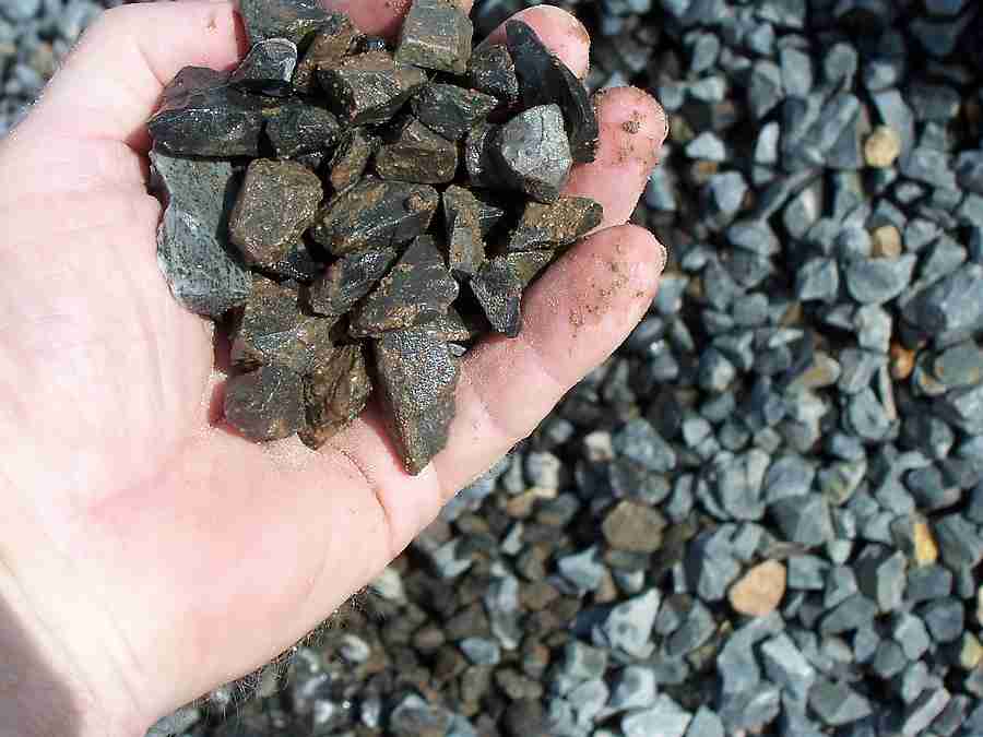 Hand holding recycled aggregates for construction