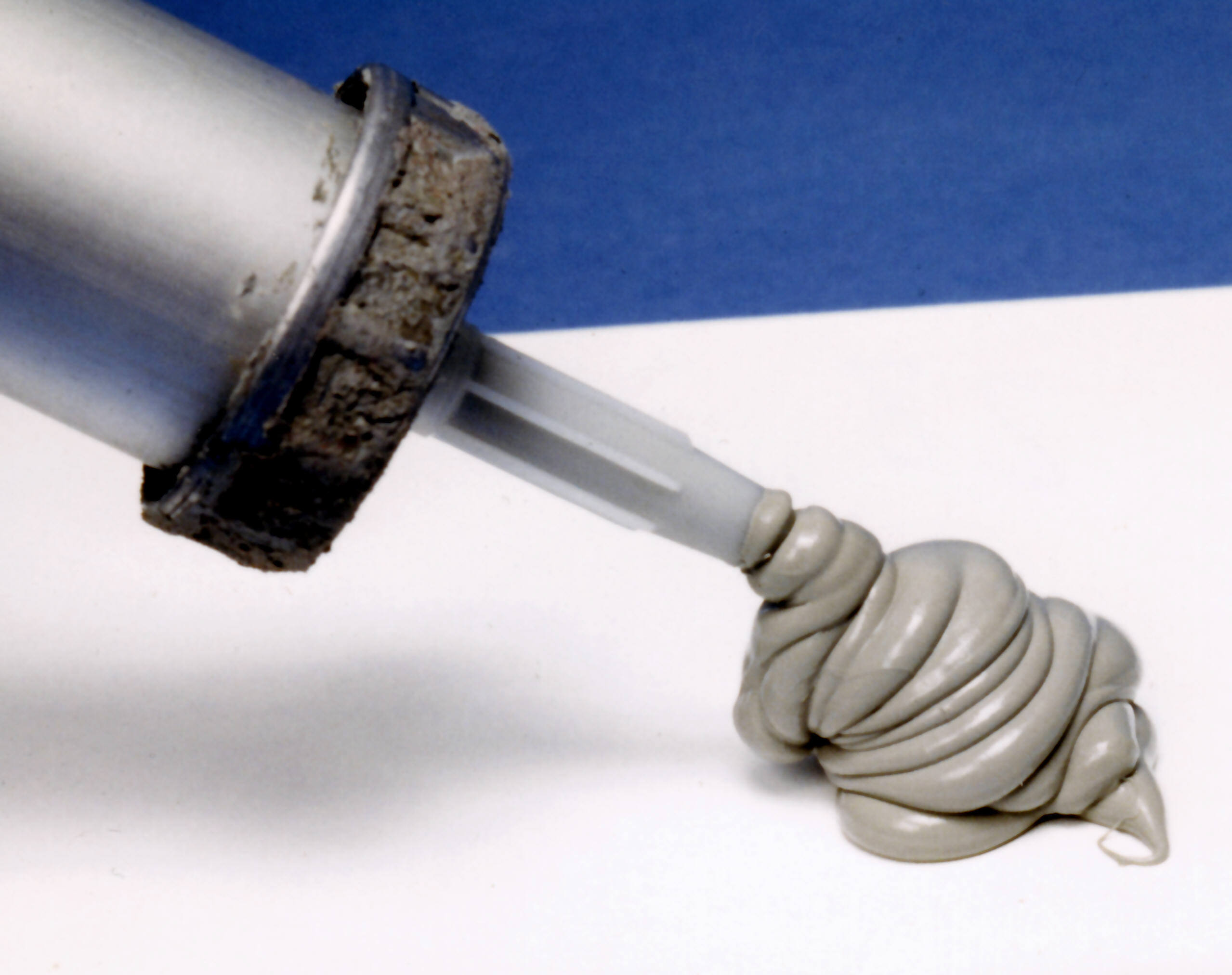 Silicone-based mastic being dispensed from a tube