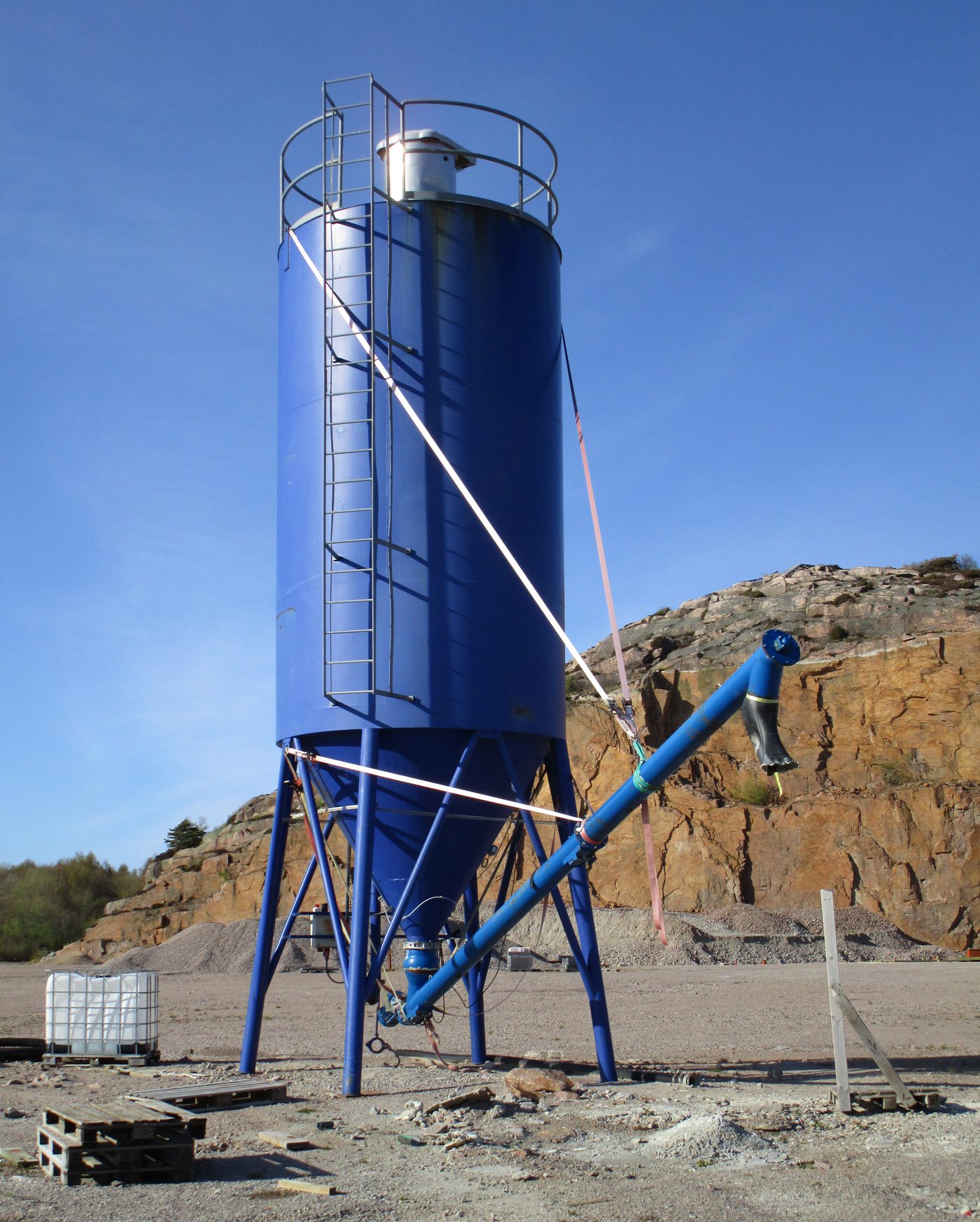 Large blue storage tank outdoors
