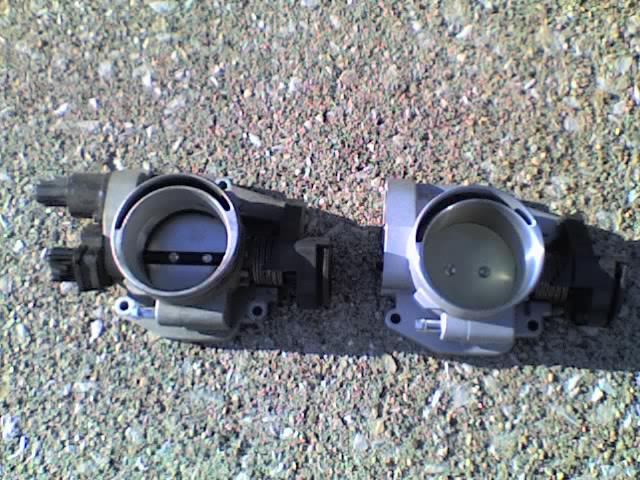 Two automotive throttle bodies side by side