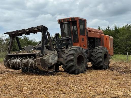 A tractor at work clearing land.
