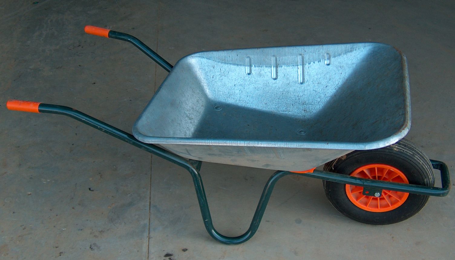 A single metal wheelbarrow with one wheel